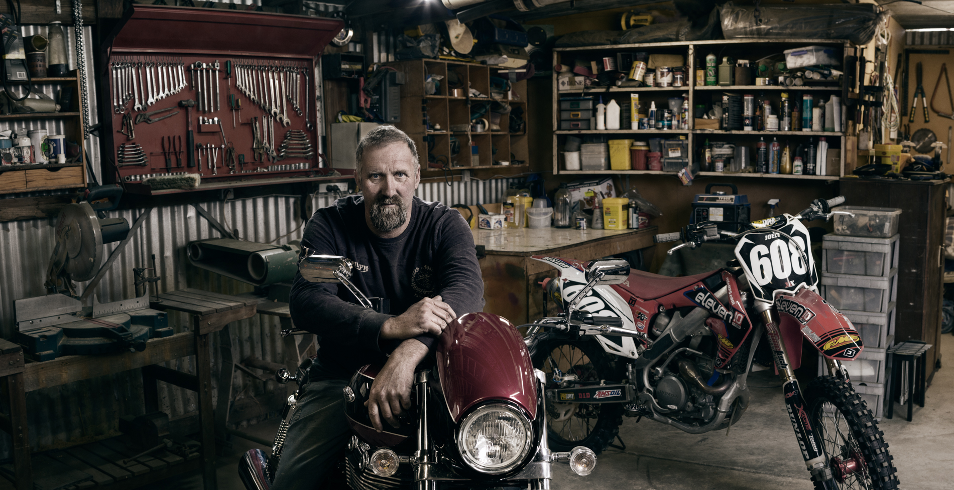 Dale general shedder and his Triumph motorcycle environmental portrait
